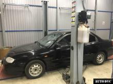 Installing a set of spacers to increase the ground clearance Kia Spectra Lift Kits (leveling kits and coil spring spacer\strut spacer)